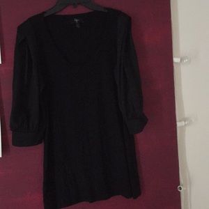 Black scoop neck top with satiny sleeves.